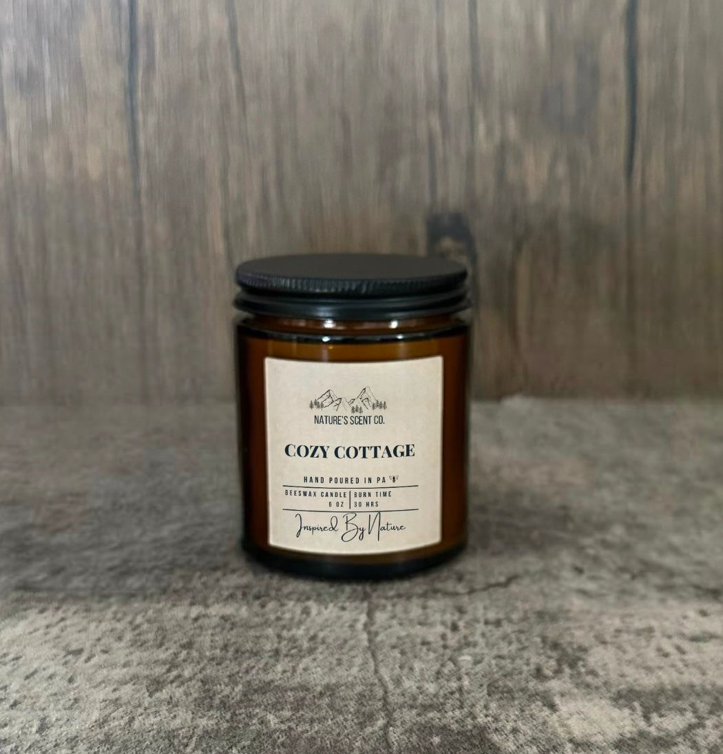 Cozy Cottage candle, all natural beeswax with a wood in an amber glass jar for a comforting, rustic aroma